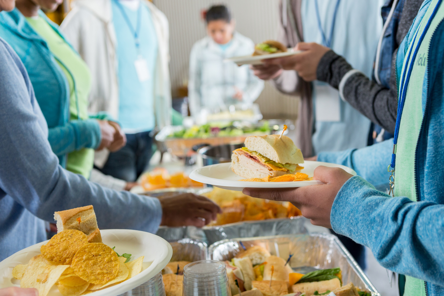 Volunteers serving food in soup kitchen